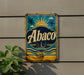 a vintage-style metal sign with the word "Abaco" displayed prominently in the center.