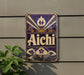 a vintage-style sign with the word "Aichi" prominently displayed, mounted on a wall.