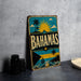 A vintage-style sign for the Bahamas, featuring a tropical beach scene with palm trees, a sun, and a boat.
