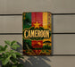 a colorful sign with the word "Cameroon" prominently displayed, surrounded by various decorative elements such as a palm tree, a sun, and a mountain.