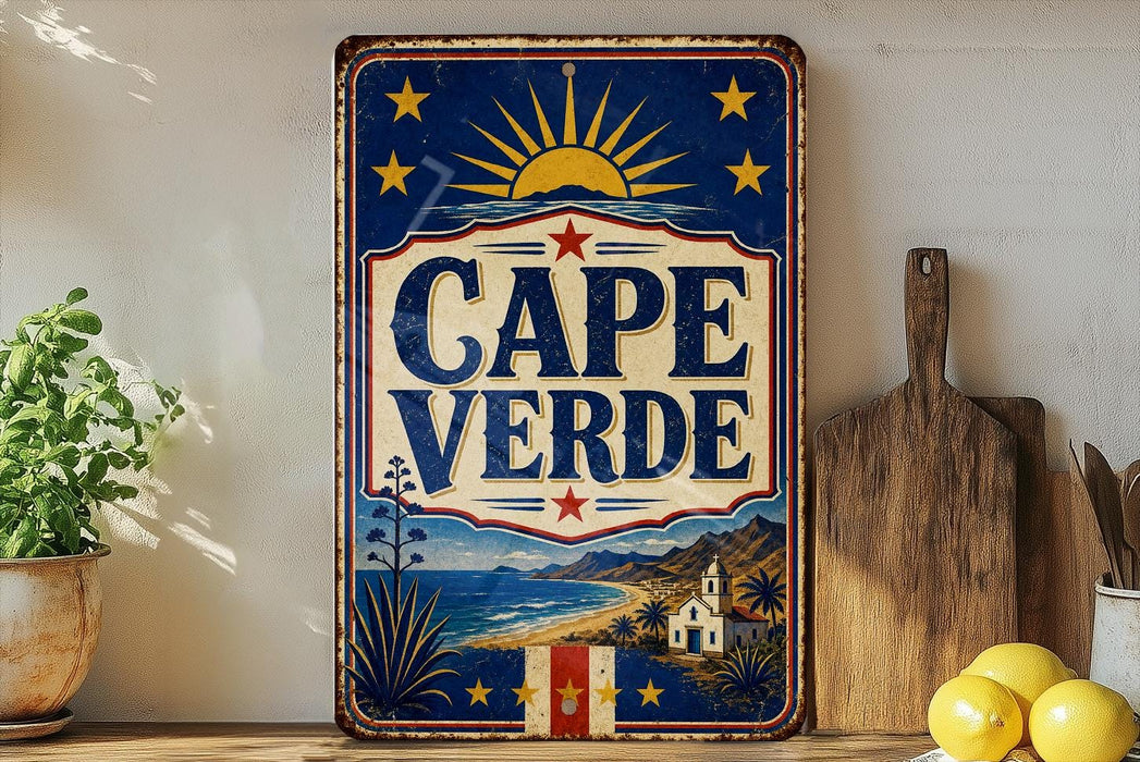 a vintage-style metal sign with a blue background, red and white border, and a sun and star design. The sign prominently displays the text "CAPE VERDE" in large letters. The sign is placed on a shelf next to a wooden cutting board and a potted plant, creating a rustic and charming atmosphere.
