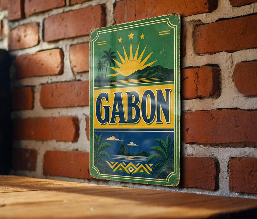 A vintage metal sign with the word "GABON" displayed prominently, featuring a sun and palm trees, is mounted on a brick wall.