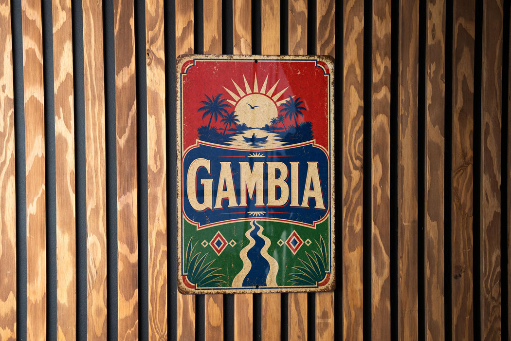 A vintage-style sign with the word "GAMBIA" prominently displayed, featuring a tropical landscape with palm trees and a sun.