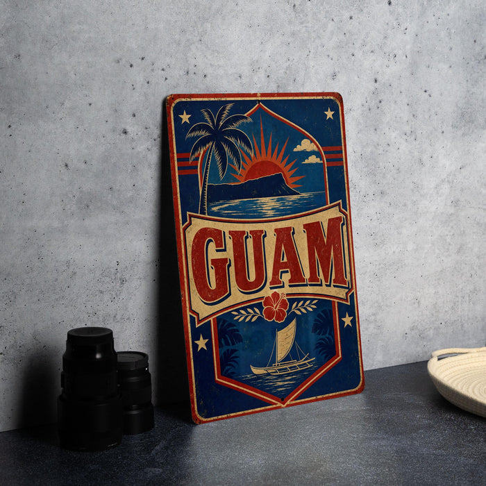 A vintage-style metal sign with the word "GUAM" prominently displayed, featuring a palm tree, sun, and other tropical elements.