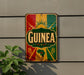 a colorful sign with the word "GUINEA" prominently displayed, mounted on a wall.
