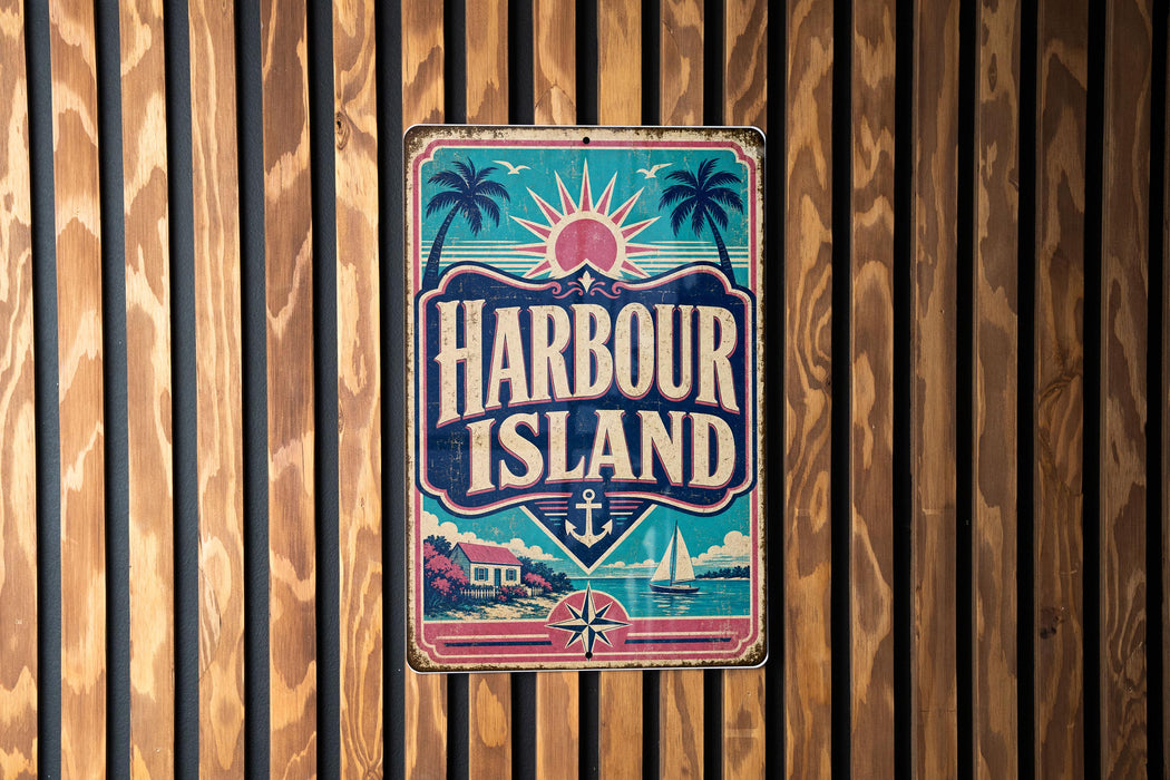 A vintage-style sign for Harbour Island, featuring a palm tree, sun, and other nautical elements, is displayed on a wooden wall.