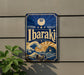 A vintage-style metal sign with the word "Ibaraki" displayed prominently, featuring a wave and a sun design.