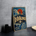 A vintage-style metal sign with the text "Ishikawa" prominently displayed, featuring a lighthouse and a sunset in the background.