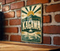 A vintage-style sign with the word "KAGAWA" prominently displayed, featuring a sun and mountain landscape design.