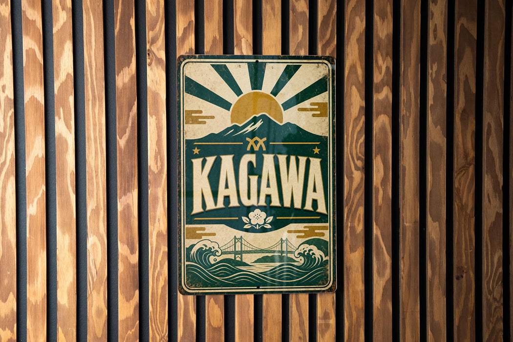 A vintage metal sign with the word "KAGAWA" prominently displayed, featuring a sun and mountain design.