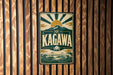 A vintage metal sign with the word "KAGAWA" prominently displayed, featuring a sun and mountain design.
