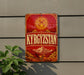 a sign with the word "KYRGYZSTAN" prominently displayed, along with a sun and mountains in the background.