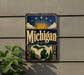 A vintage-style metal sign with the word "Michigan" prominently displayed, featuring a sun and clouds design, and a maple leaf.