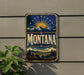 A vintage metal sign with the word "Montana" prominently displayed, featuring a mountain landscape with a sun and stars in the background.