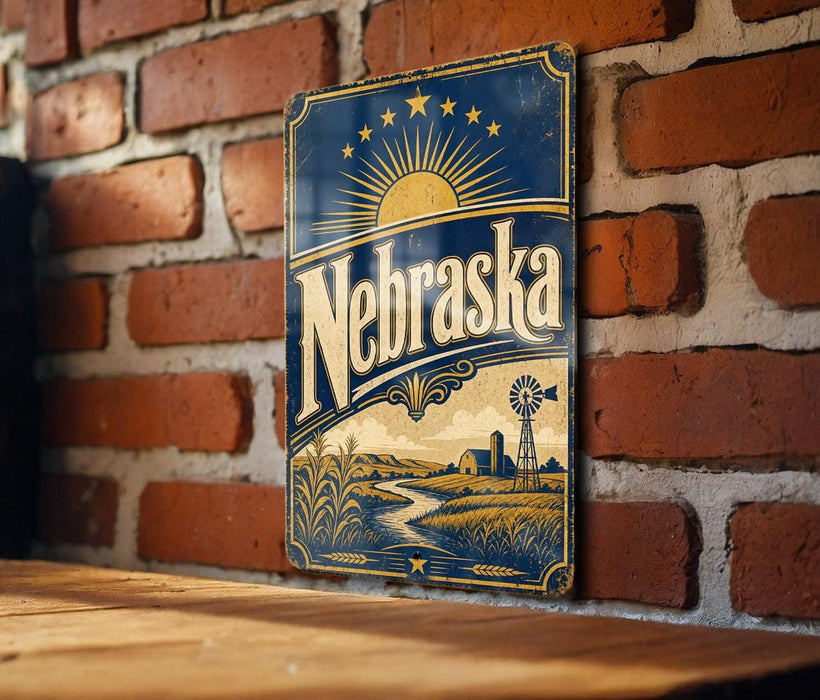 A vintage-style metal sign with the word "Nebraska" prominently displayed, featuring a sun and windmill illustration, mounted on a brick wall.