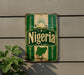 a vintage-style sign with the word "Nigeria" prominently displayed, mounted on a wall.