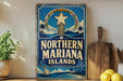A vintage-style sign for the Northern Mariana Islands, featuring a blue background with a white star and tropical imagery, is displayed on a shelf next to a wooden cutting board and a potted plant.