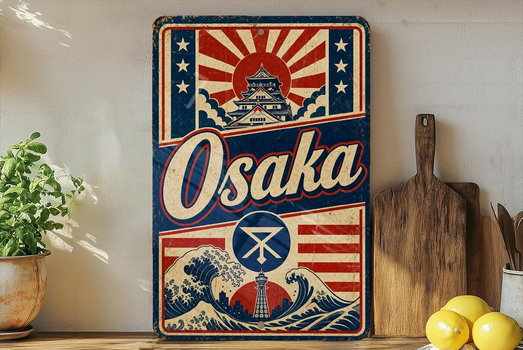 a vintage-style sign for Osaka, with a wave and Japanese temple design, placed on a shelf next to a wooden cutting board and some lemons.