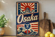 a vintage-style sign for Osaka, with a wave and Japanese temple design, placed on a shelf next to a wooden cutting board and some lemons.