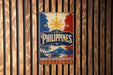 A vintage-style metal sign with the word "PHILIPPINES" prominently displayed, featuring a sun and palm trees, against a wooden background.