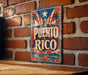 A vintage-style sign with the text "PUERTO RICO" is displayed on a brick wall, with palm trees and a sunset in the background.
