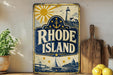 A vintage-style sign for Rhode Island featuring a lighthouse, sun, and ship, along with the text "RHODE ISLAND" prominently displayed.