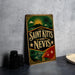 A vintage-style sign for Saint Kitts and Nevis, featuring a tropical landscape with palm trees and a sun.