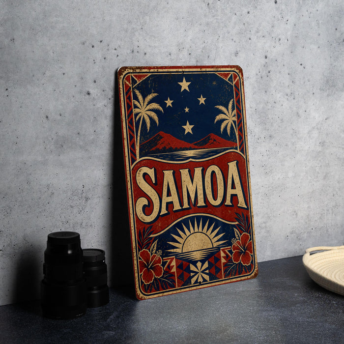a vintage-style sign with the word "SAMOA" prominently displayed, along with a tropical landscape and stars. The sign is placed on a gray surface, and there are some black objects, such as a stack of cups, to the left of the sign.
