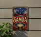 a vintage-style sign with the word "SAMOA" prominently displayed, surrounded by tropical elements such as palm trees and a sun.