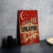 A vintage-style metal sign with the word "SINGAPORE" prominently displayed, featuring a crescent moon and stars, and an illustration of the city skyline.