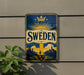 A vintage-style sign with the word "SWEDEN" prominently displayed, featuring a sunburst design and a castle in the background.