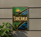 a sign with the word "Tanzania" prominently displayed, surrounded by various decorative elements such as a sun, palm trees, and a mountain.