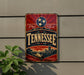 A vintage-style sign for Tennessee, featuring a red and blue design with a prominent star and the word "Tennessee" written in large letters.