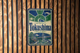 A vintage-style sign for "Tokushima" is displayed on a wooden wall.