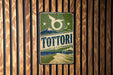 A vintage-style sign for "Tottori" is displayed on a wooden wall.