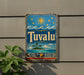 a vintage-style sign with a tropical island and palm trees, along with a sun and stars, mounted on a wall.