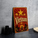 A vintage-style metal sign with the word "Vietnam" prominently displayed, featuring a red background with a yellow star and a sunset landscape.