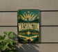 A vintage-style metal sign with the word "WASHINGTON" prominently displayed, featuring a mountain landscape and sunburst design.