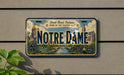 A license plate from Notre Dame, Indiana, with the text "South Bend, Indiana, Home of the Fightin' Irish" and "Notre Dame" prominently displayed.