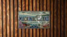 A vintage license plate from Michigan's Crown Jewel, featuring the name "Mackinac Island" and the location "Lake Huron".