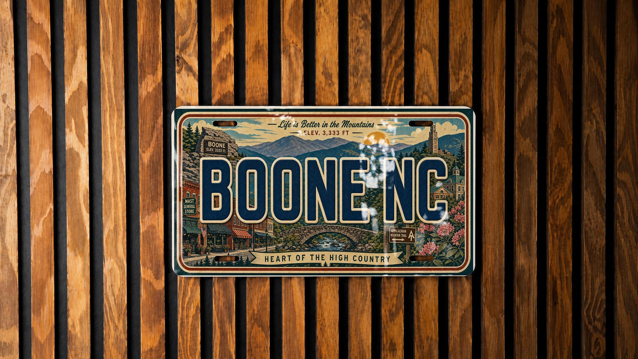 A vintage license plate from Boone, North Carolina, with a scenic mountain landscape and the text "Life is Better in the Mountains" displayed on it.