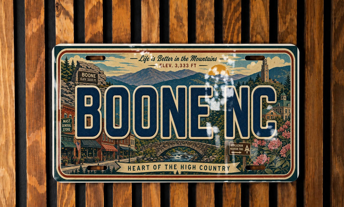 A vintage license plate from Boone, North Carolina, with a scenic mountain landscape and buildings in the background.