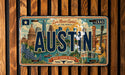 A vintage license plate from Texas featuring the city of Austin, with various landmarks and elements that represent the state.