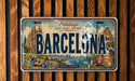 A vintage Barcelona license plate with a colorful illustration of the city's landmarks and scenery.