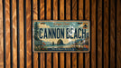 A license plate from Oregon Coast, featuring a scenic illustration of Cannon Beach and surrounding landscape.