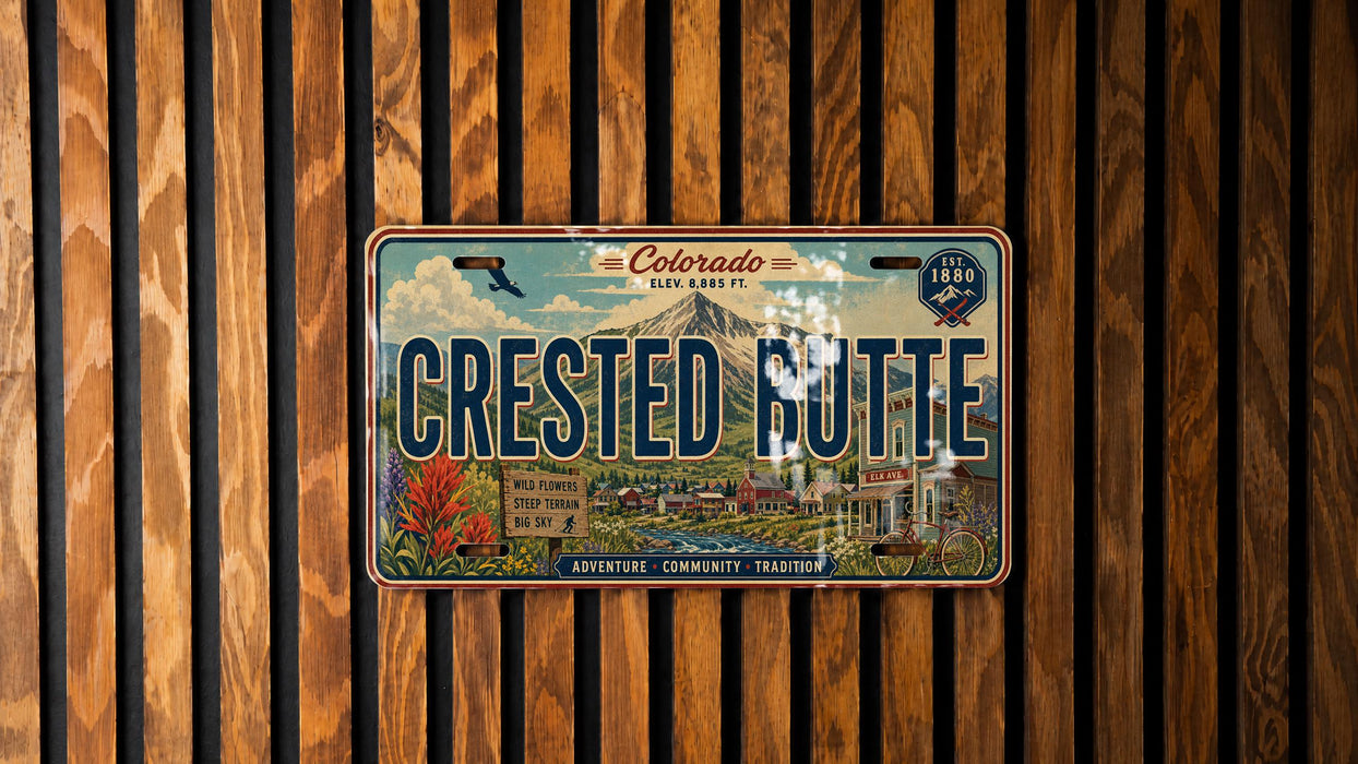 A vintage-style license plate from Colorado, with the text "Crested Butte" prominently displayed.