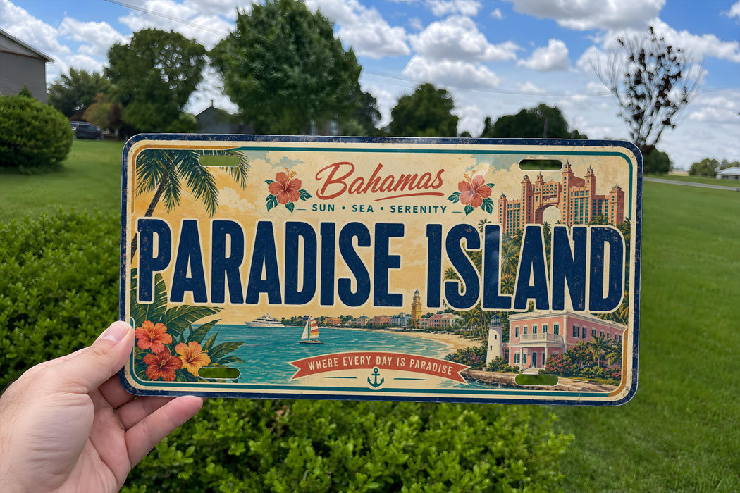 A vintage license plate from Paradise Island, featuring a tropical beach scene and palm trees.