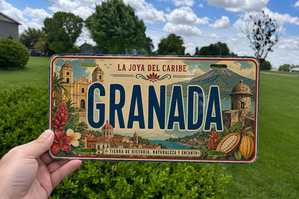 A person is holding a license plate with the word "Granada" on it, which is a tropical island in the Caribbean.