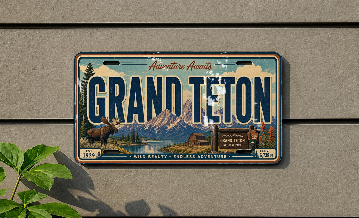 A vintage license plate from Grand Teton National Park, featuring a scenic mountain landscape and wildlife.