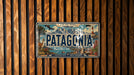 A vintage Patagonia license plate is displayed on a wooden wall.